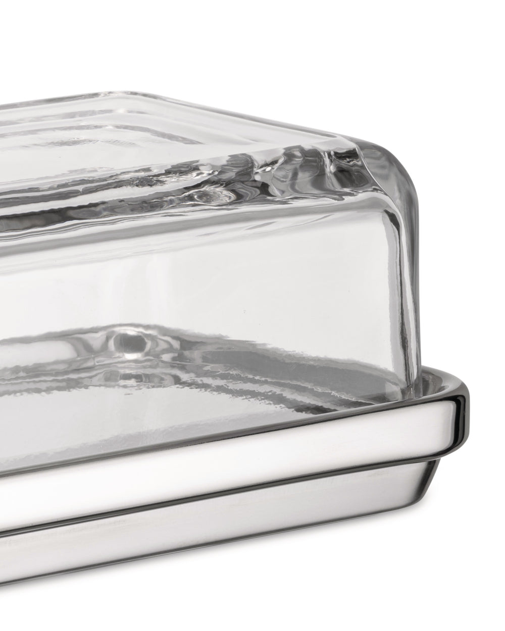 Glass and polished silver-tone butter dish by Alessi with a clear rectangular glass cover, viewed from the side.