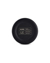 Black circular cup bottom by Alessi, engraved with brand, designer, and material details in a contrasting white grid.