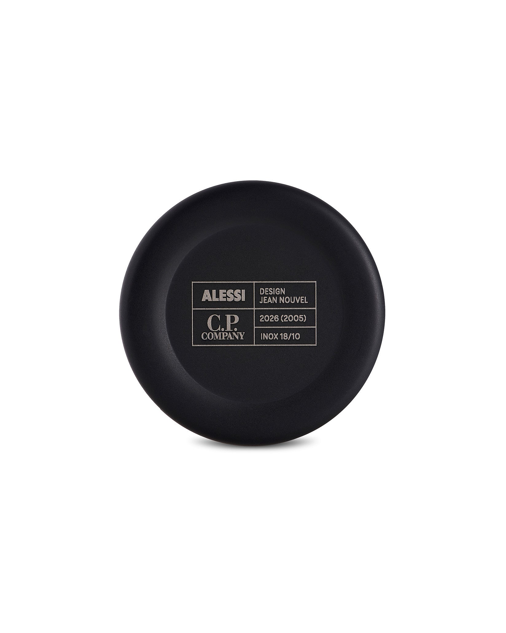 Black circular cup bottom by Alessi, engraved with brand, designer, and material details in a contrasting white grid.