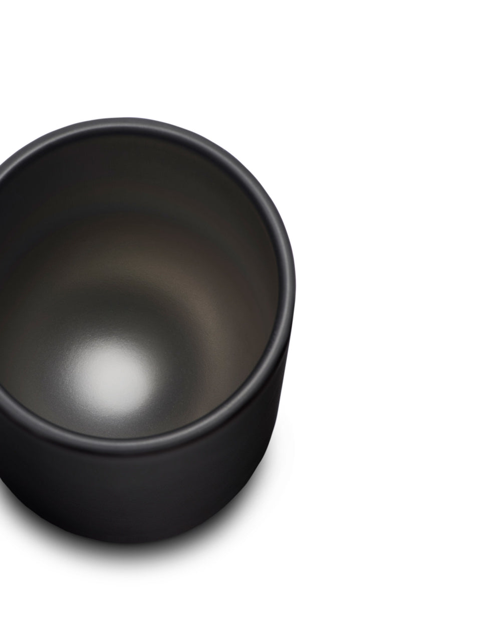 Black cup by Alessi with a smooth matte exterior and a glossy light reflection inside.