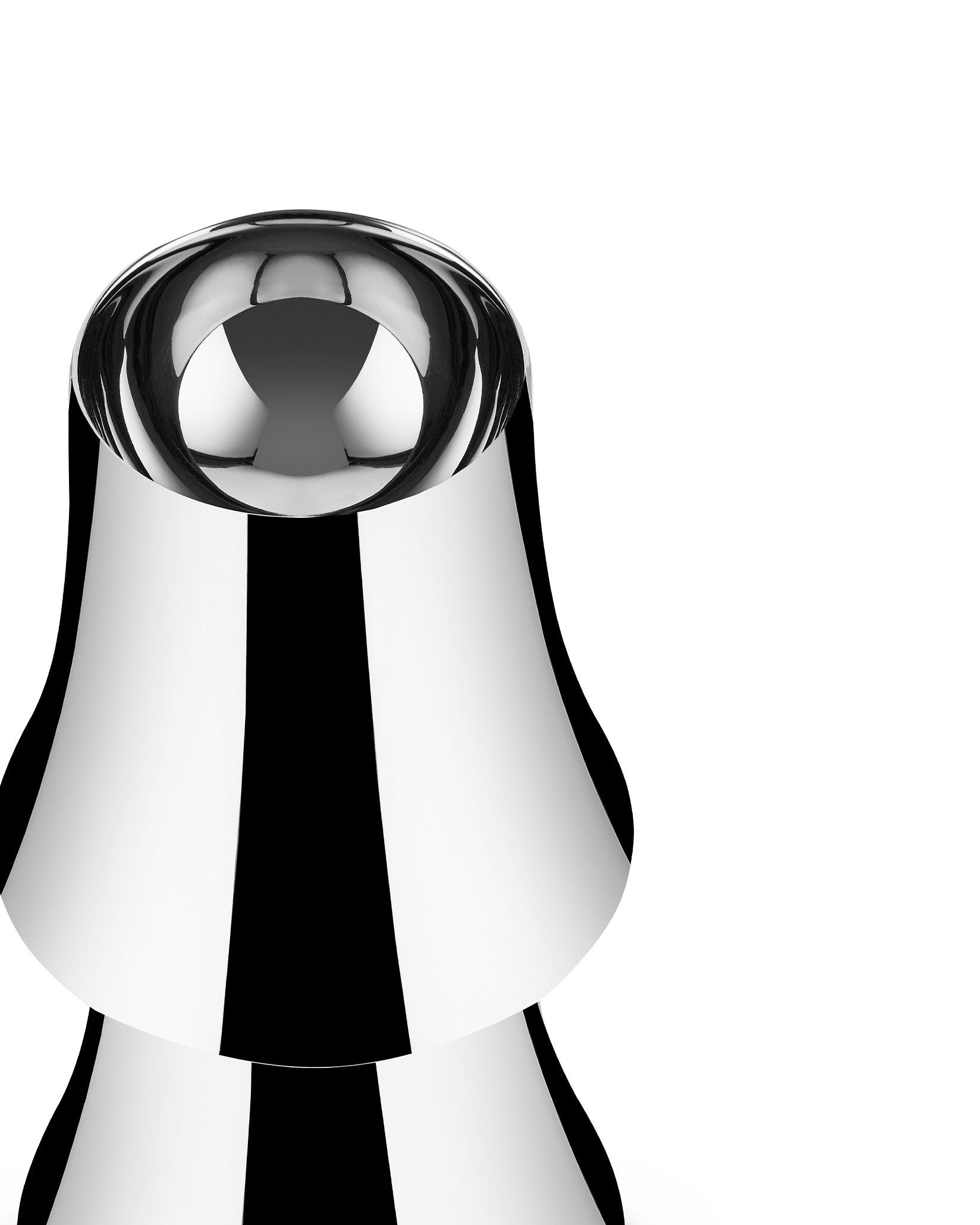Chrome-plated lamp by Alessi with a sculptural, reflective surface showing bold black and white stripes.