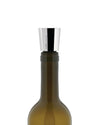 Silver metallic wine stopper by Alessi, a conical design inscribed with text, inserted into a dark glass bottle.