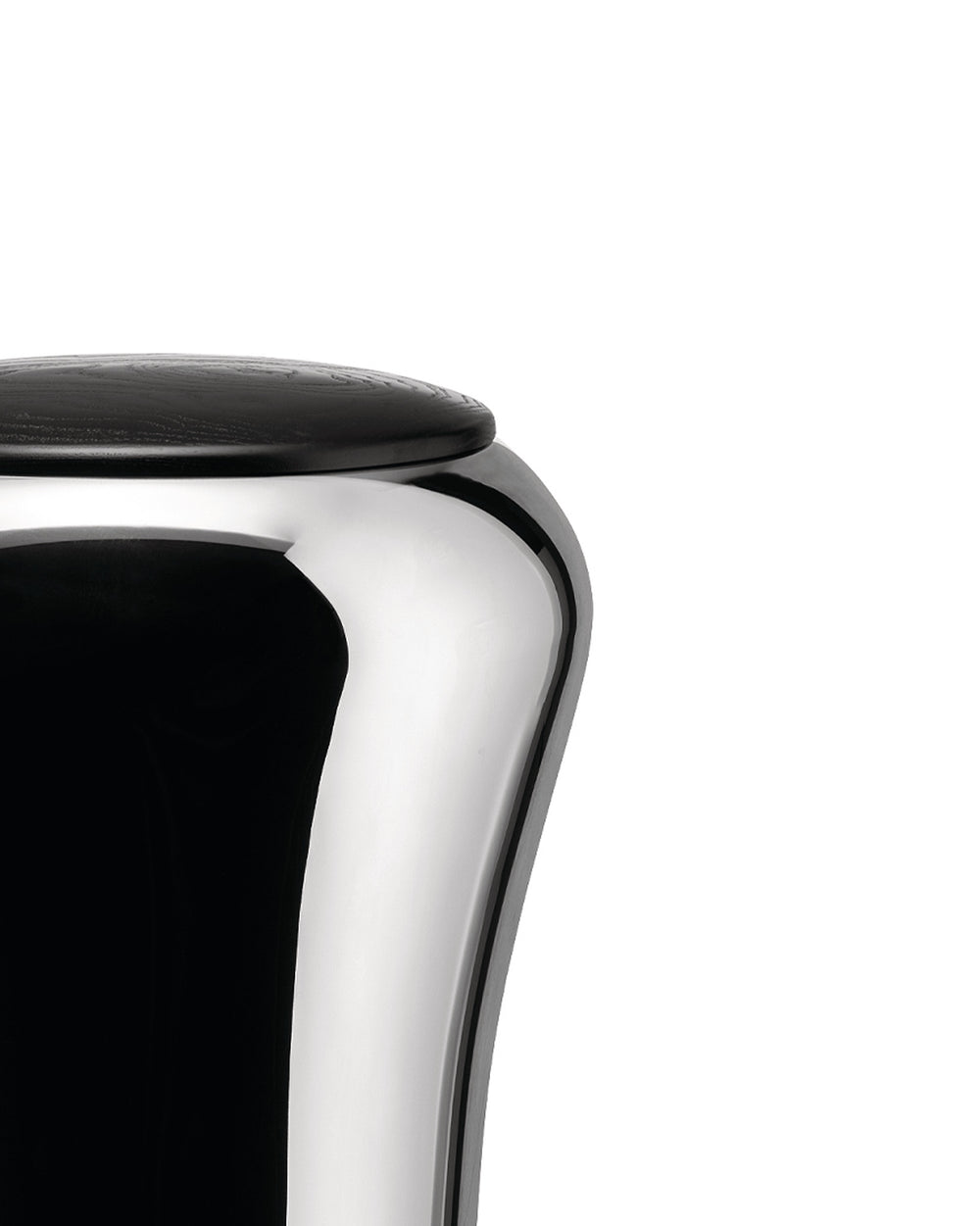 Polished chrome laundry basket with a black wood lid by Alessi, showing a curved body and wood grain texture, cropped side view.
