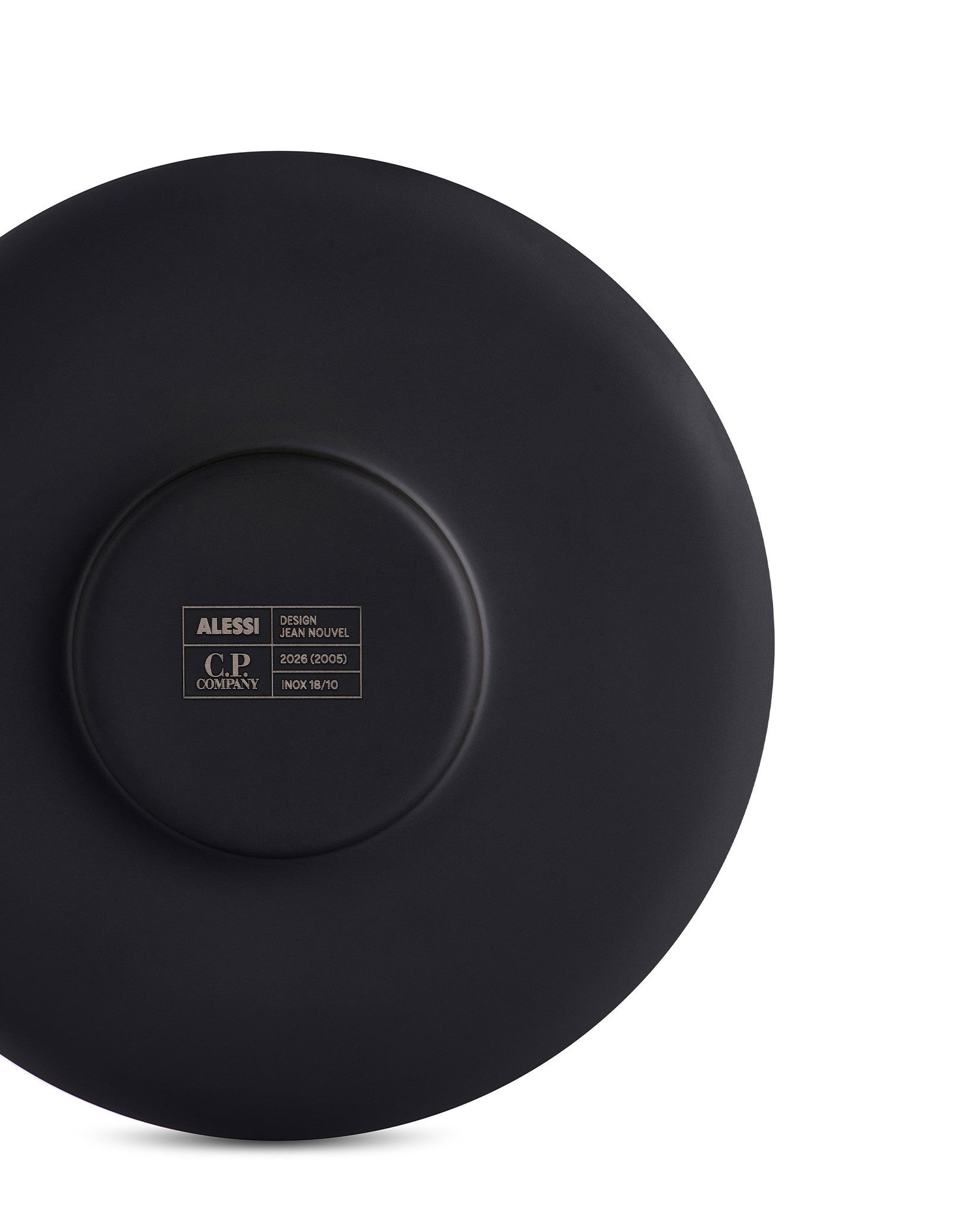 Dark matte black cup by Alessi, showing its underside with engraved brand, designer, and material details.