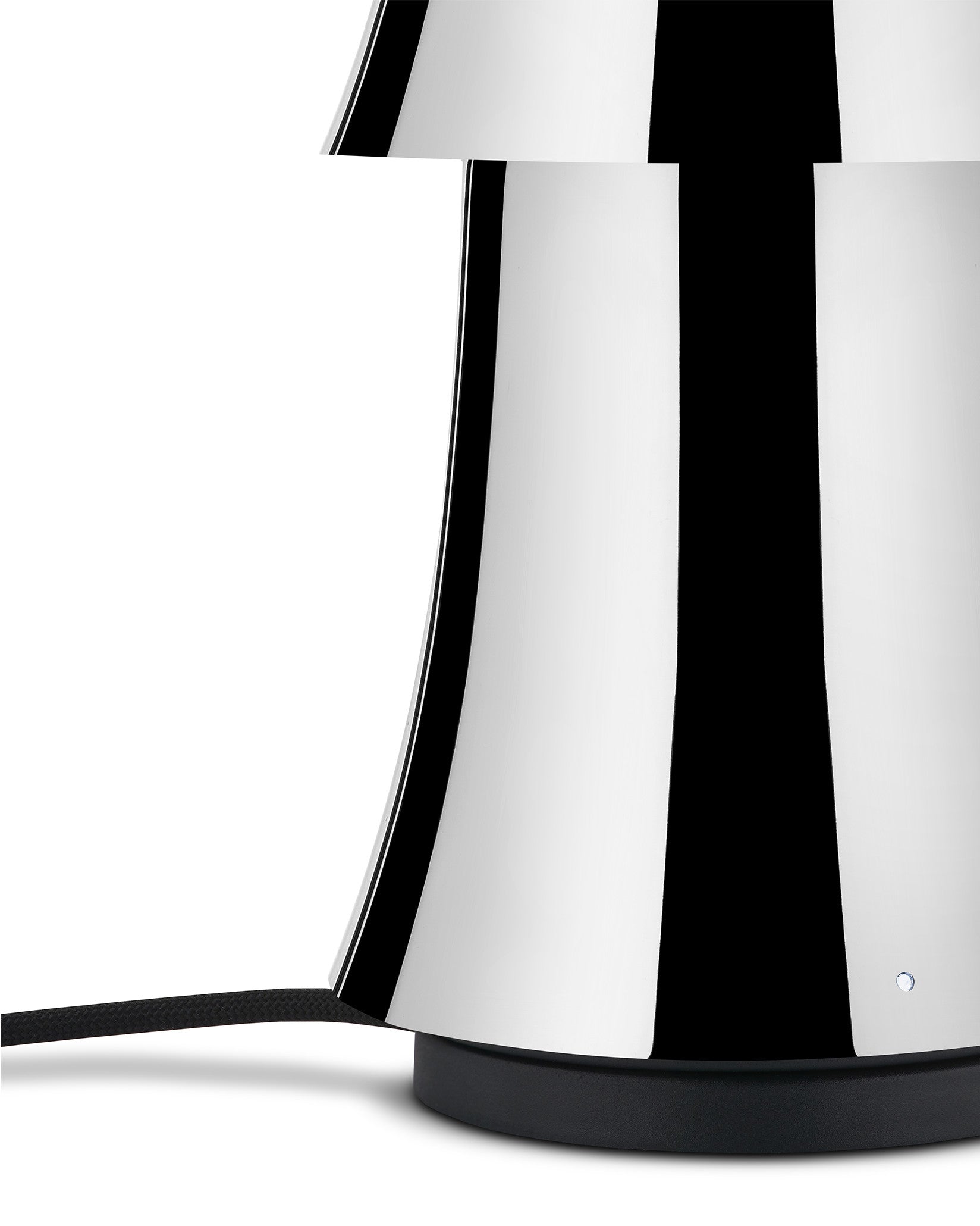 Polished chrome lamp by Alessi with a prominent black vertical striped design, a black braided cord, and an illuminated base button.