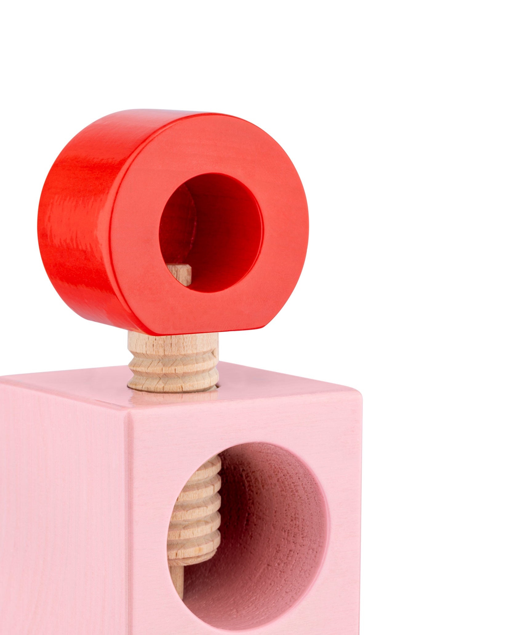 Cropped view of a red and pink wooden nutcracker ES20 by Alessi, showing its large threaded screw.