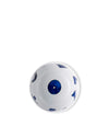 White ceramic bowl by Alessi with a central dark blue circle containing a white dot, and scattered abstract dark blue shapes, viewed from above.