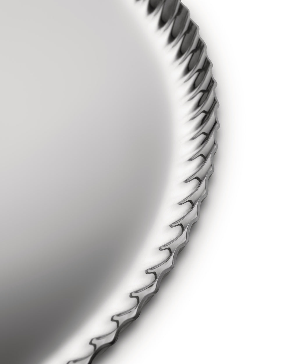 Silver metallic tray by Alessi with a decorative pleated edge, cropped view on a white background.