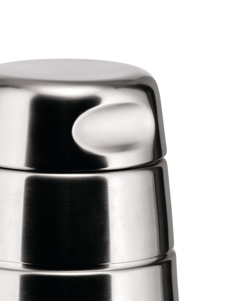 Stainless steel cocktail shaker by Alessi, close-up with a brushed metallic finish and curved indentations.