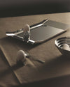 Sleek silver Arran tray by Alessi with rounded corners, styled with eggs in geometric cups.
