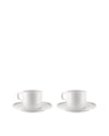 Two white ceramic cups by Alessi, each with a handle and matching round saucer.