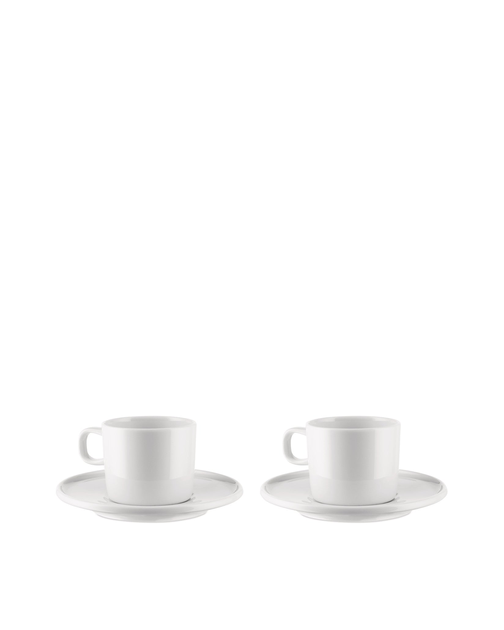 Two white ceramic cups by Alessi, each with a handle and matching round saucer.