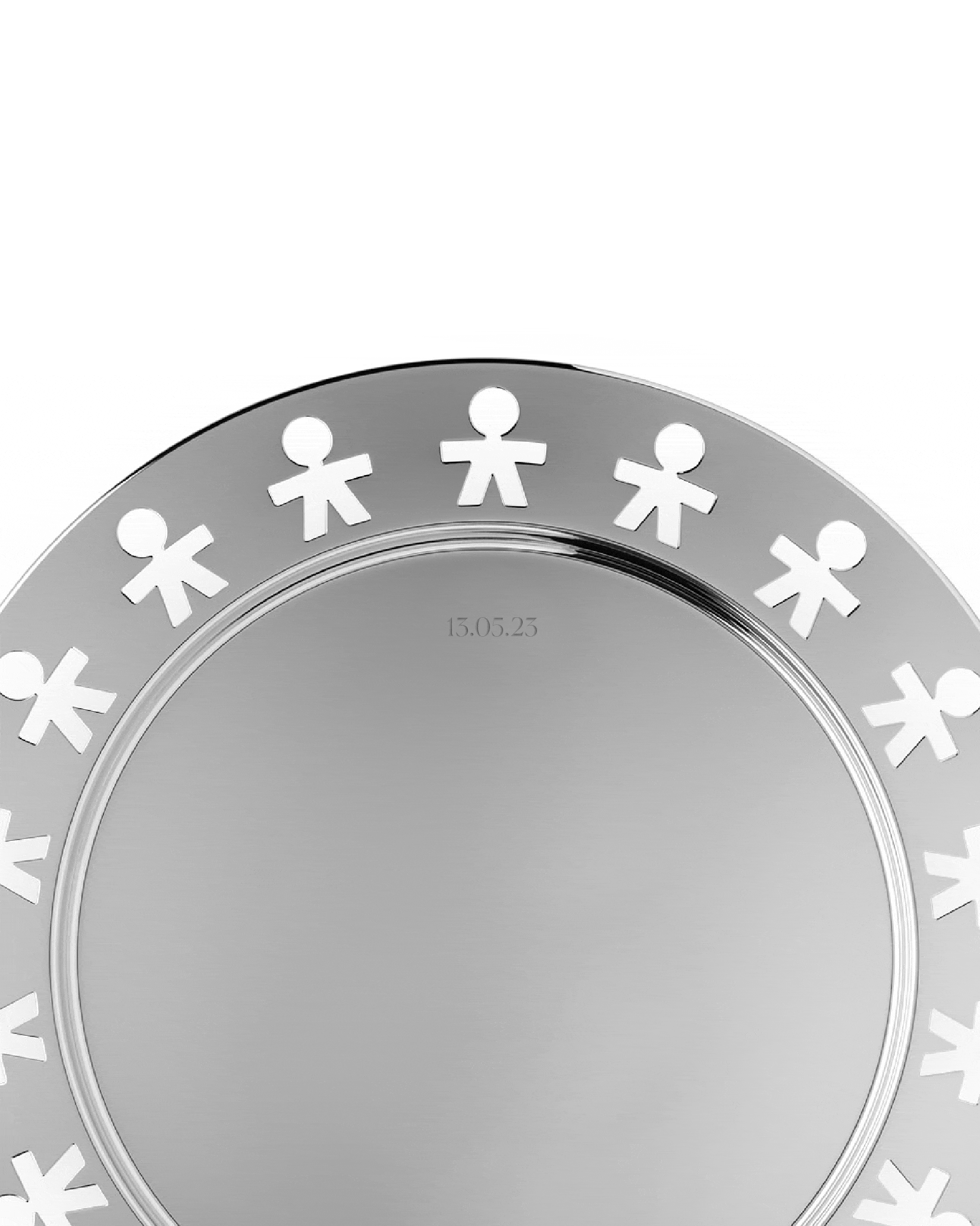 Silver metal tray with cutout human figures by Alessi, engraved with the date 13.05.23 in a close-up.
