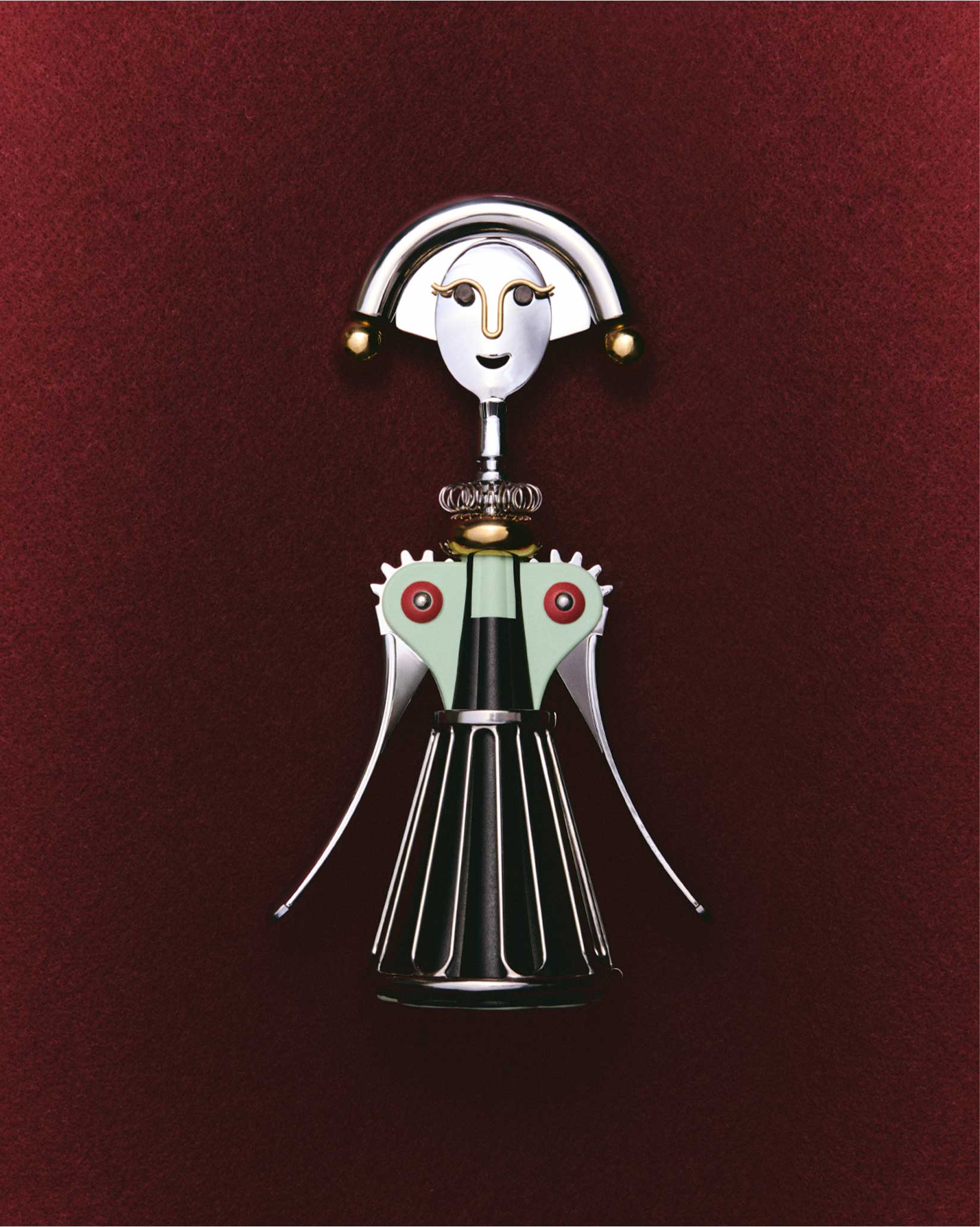 A silver, black, and mint green corkscrew by Alessi, designed as a stylized woman with a smiling face, on a deep red background.