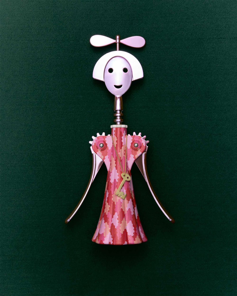 Anna G. corkscrew by Alessi, designed as a smiling woman with a pink patterned dress, propeller hat, and gold key pendant.