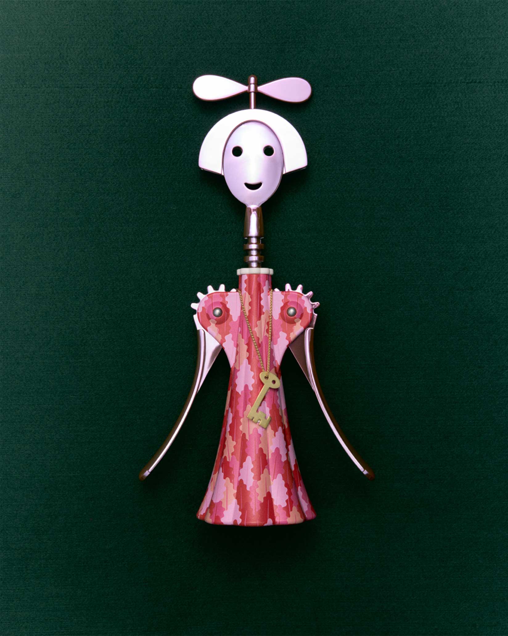 Anna G. corkscrew by Alessi, designed as a smiling woman with a pink patterned dress, propeller hat, and gold key pendant.