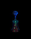 Anthropomorphic corkscrew by Alessi with a blue dog-like head, teal body with red pattern, and glowing green "ALESSI" text.