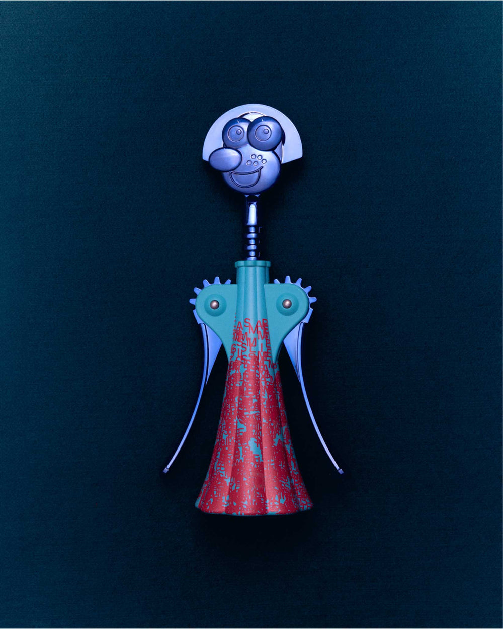Anna G. figurative corkscrew by Alessi, with a silver smiling face, teal body, and red patterned skirt.
