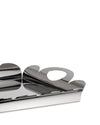Silver polished stainless steel tray by Alessi with abstract, wavy sides forming an oval handle cutout, viewed at an angle.
