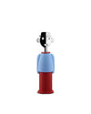Human-like corkscrew by Alessi with black and white face, blue shirt, and red pants standing upright.