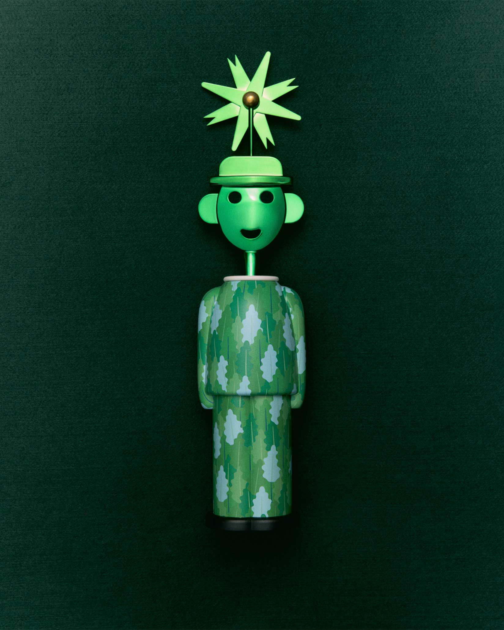 Green corkscrew by Alessi styled as a whimsical figure with a leaf-patterned body and a pinwheel hat.