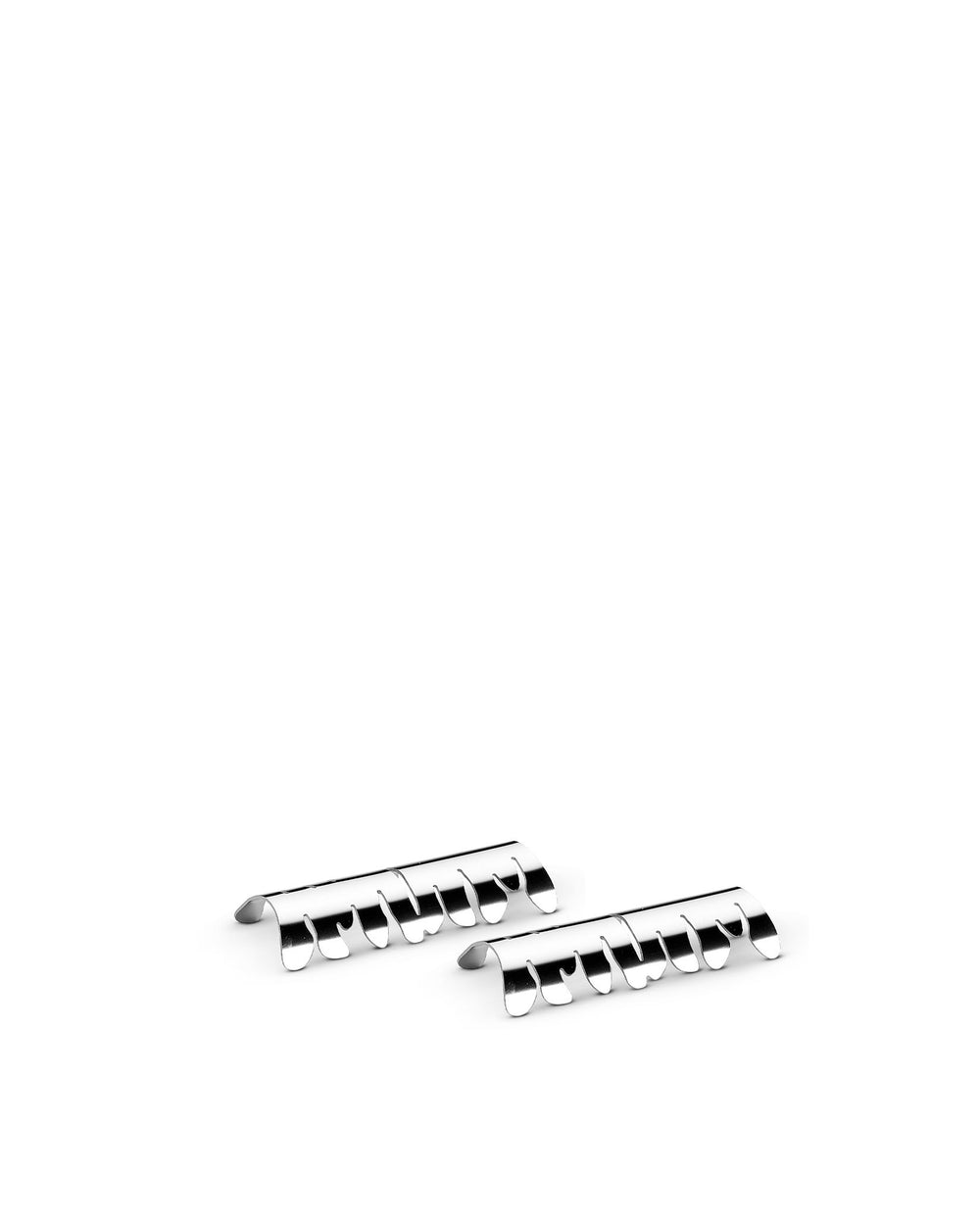 Two silver metallic cutlery rests by Alessi, each with multiple wavy, curved prongs.