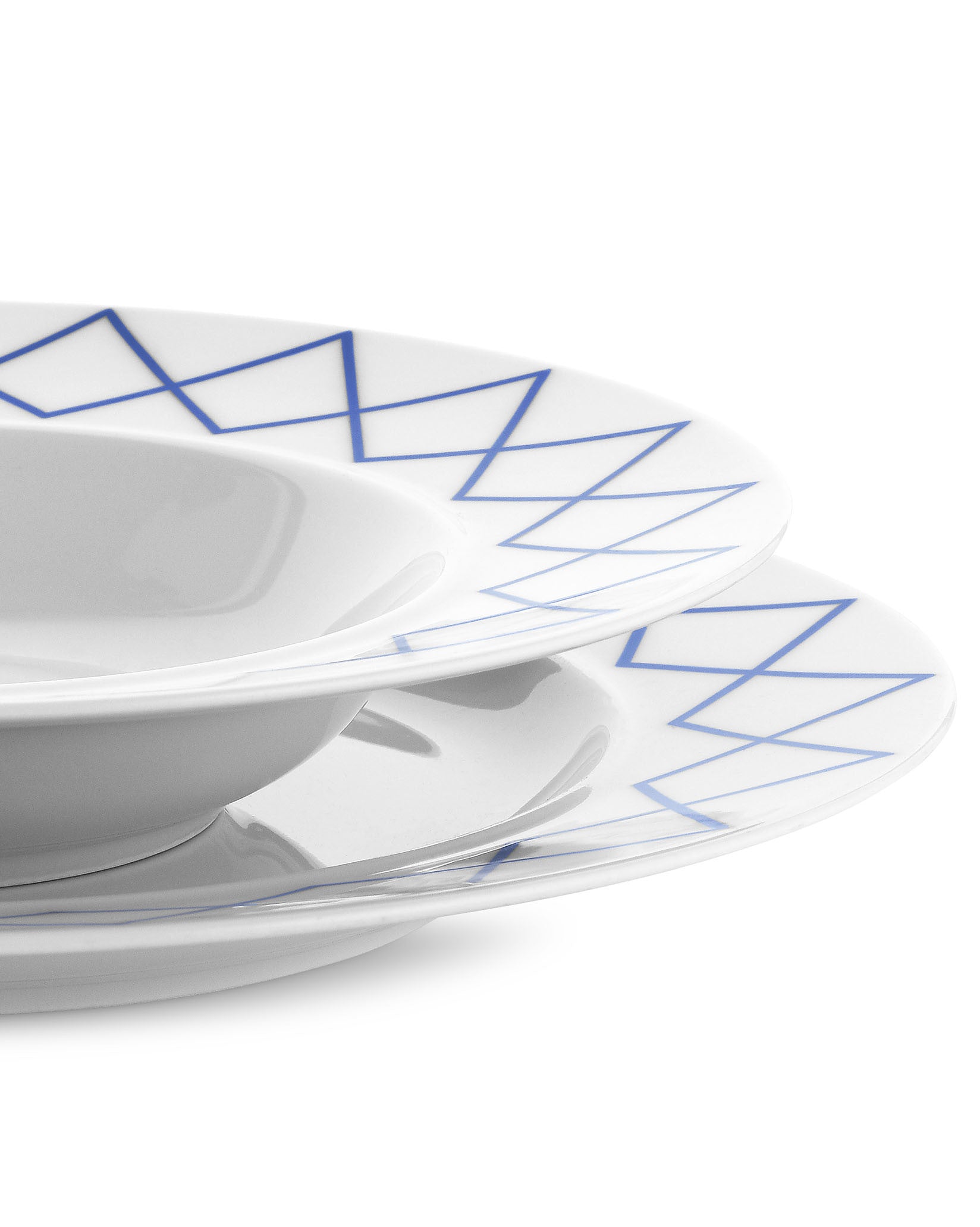 White dining plates with blue geometric criss-cross pattern by Alessi, a stacked set of a bowl and two plates.