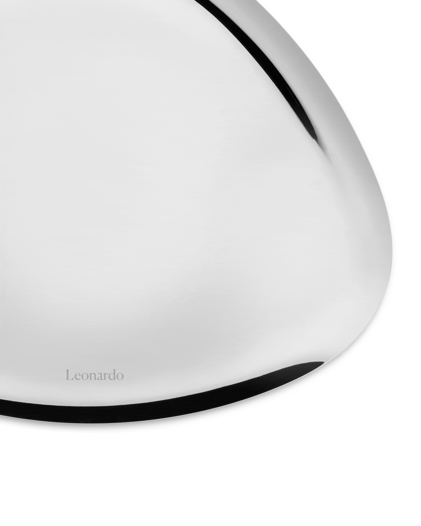 Silver metal platter by Alessi with a black curved edge and 'Leonardo' engraved on its reflective surface.