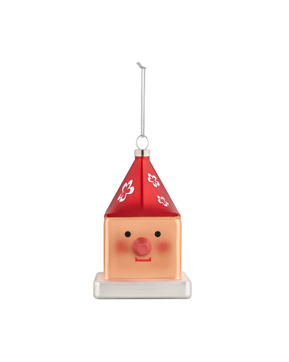 Cubocchio Christmas tree ornament by Alessi, featuring a peach cube body, red pointy roof with white flowers, two black eyes, and a pink nose.
