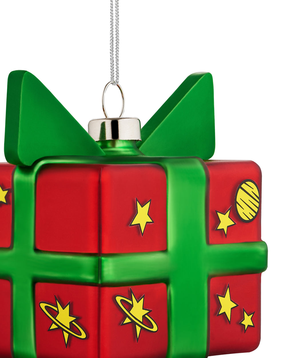 Red and green gift box Christmas tree ornament by Alessi, decorated with yellow stars and planets, with a silver hanger, cropped.