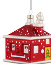 Red house-shaped Christmas tree ornament by Alessi with white polka dots, a smiling face, and a Christmas tree design.