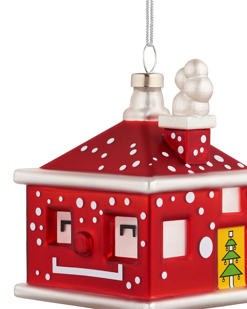 Red house-shaped Christmas tree ornament by Alessi with white polka dots, a smiling face, and a Christmas tree design.