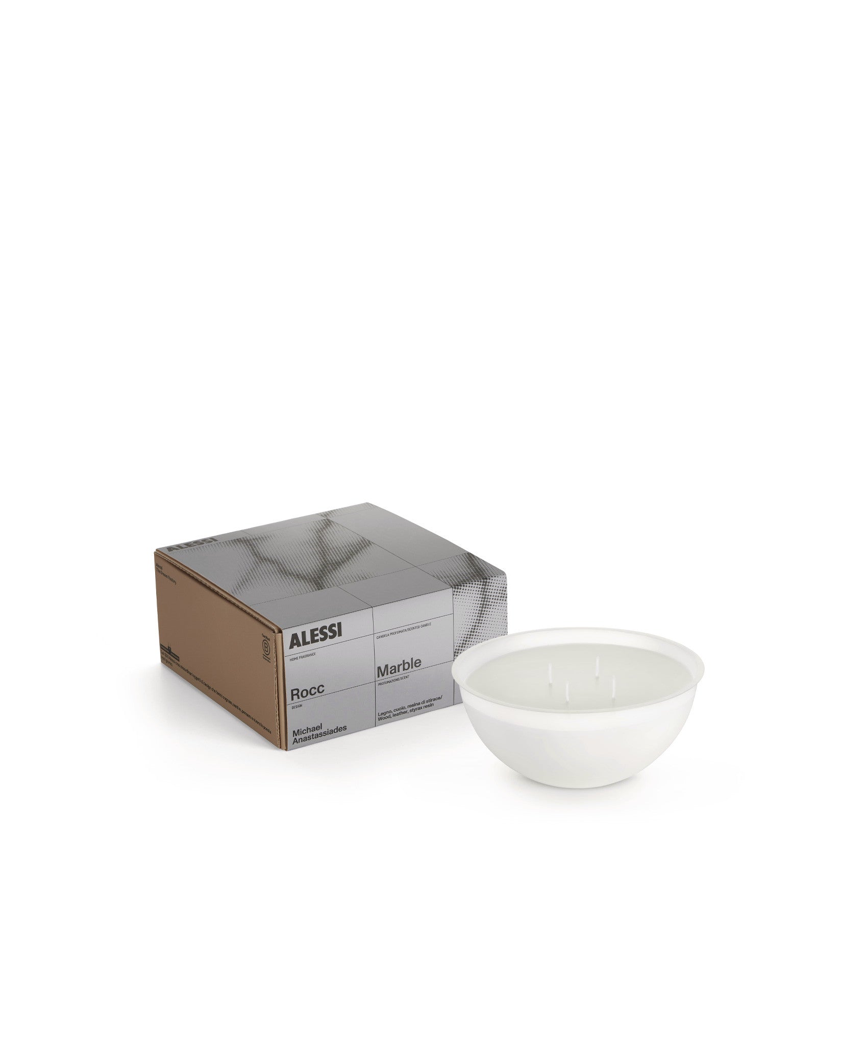 White Rocc candle by Alessi in a round bowl with three wicks, shown with its brown and gray packaging.