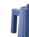 Blue pleated electric kettle by Alessi with vertical pleated texture on handle and body, cropped side view.