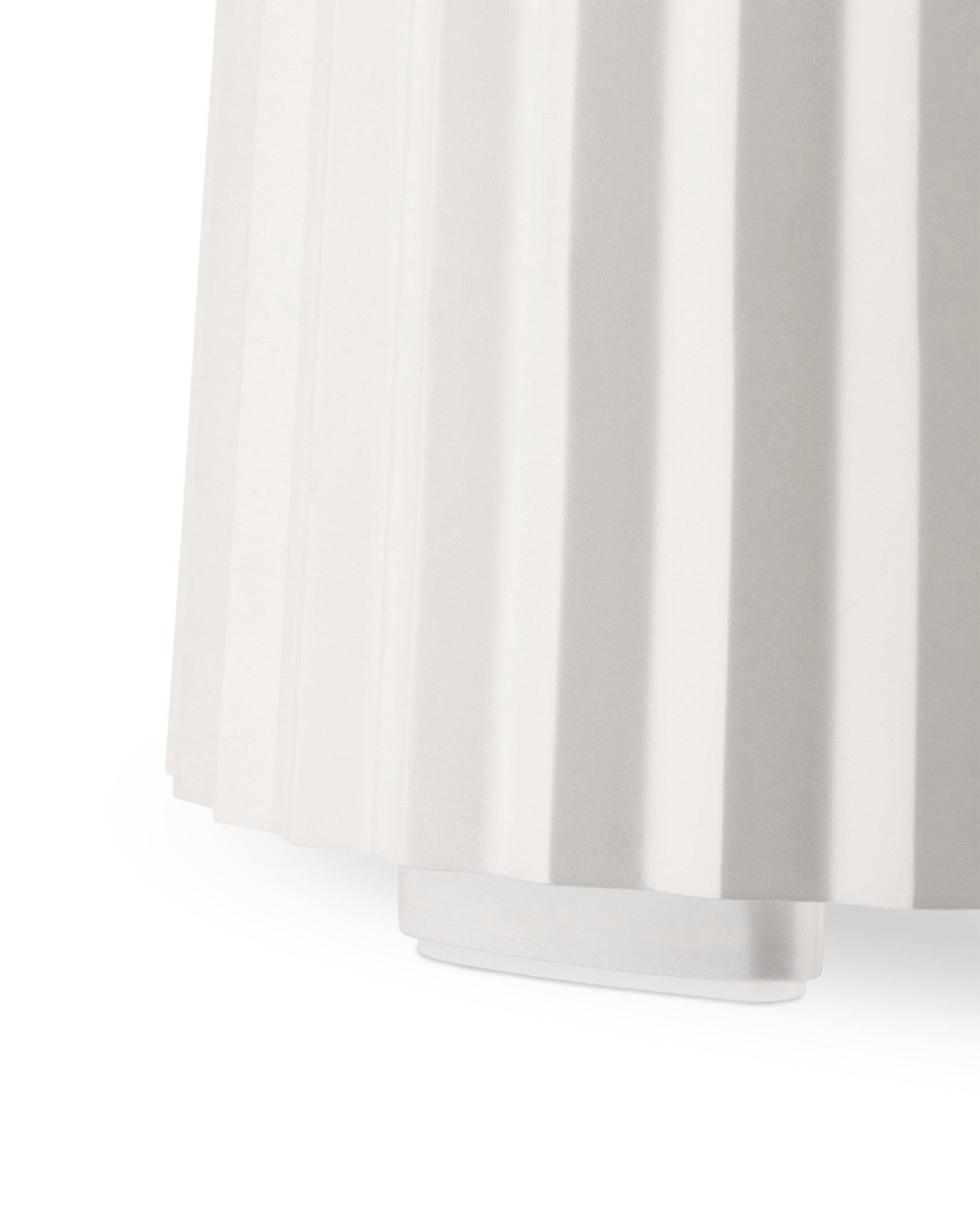 White pleated Plissé blender by Alessi, with a prominent vertical ribbed texture, cropped side view.