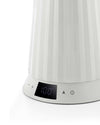 White pleated electric kettle by Alessi, showing a digital display with '100' and control buttons.