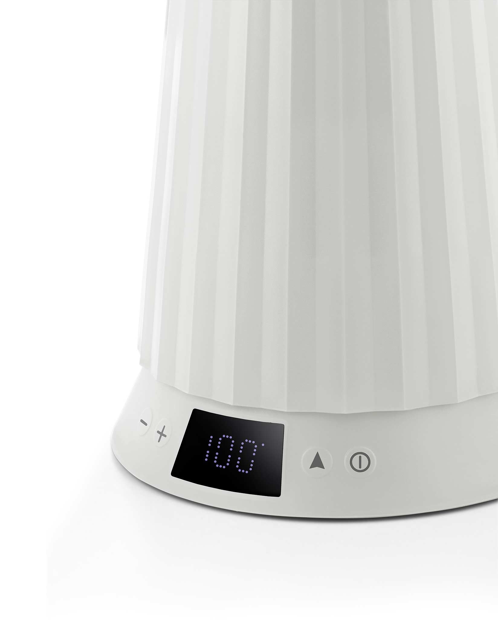 White pleated electric kettle by Alessi, showing a digital display with '100' and control buttons.
