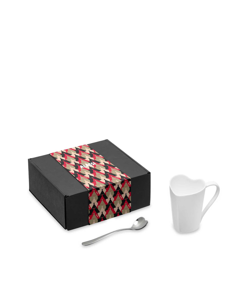 Black gift set by Alessi with a red, black, and beige geometric patterned band, a white heart-shaped mug, and a heart-tipped spoon.
