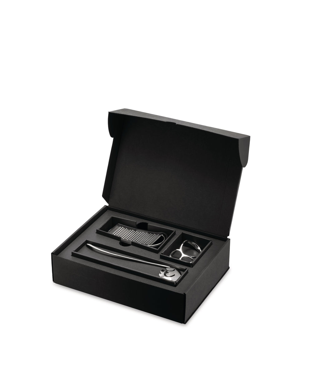 Black pasta gift set by Alessi, open with silver tools: a long spoon, grater, and pasta measure.
