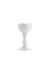 White egg cup by Alessi with a scalloped rim and elegant pedestal base, front view.