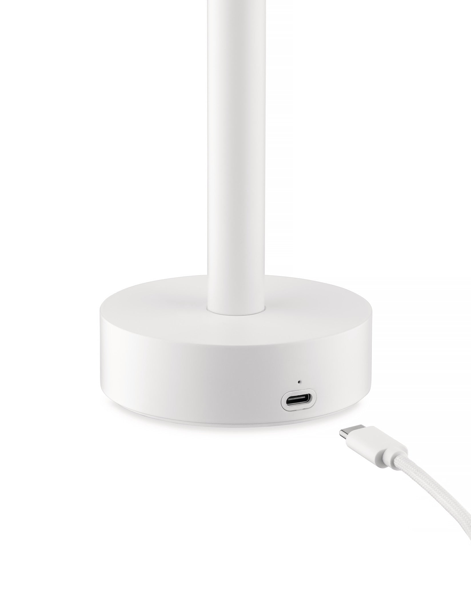 White cylindrical Tsumiki lamp by Alessi with a visible USB-C port on its round base, connecting to a braided white cable.