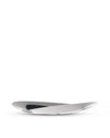 Silver-toned Octave basket by Alessi with a sleek, twisted sculptural design and dark interior.