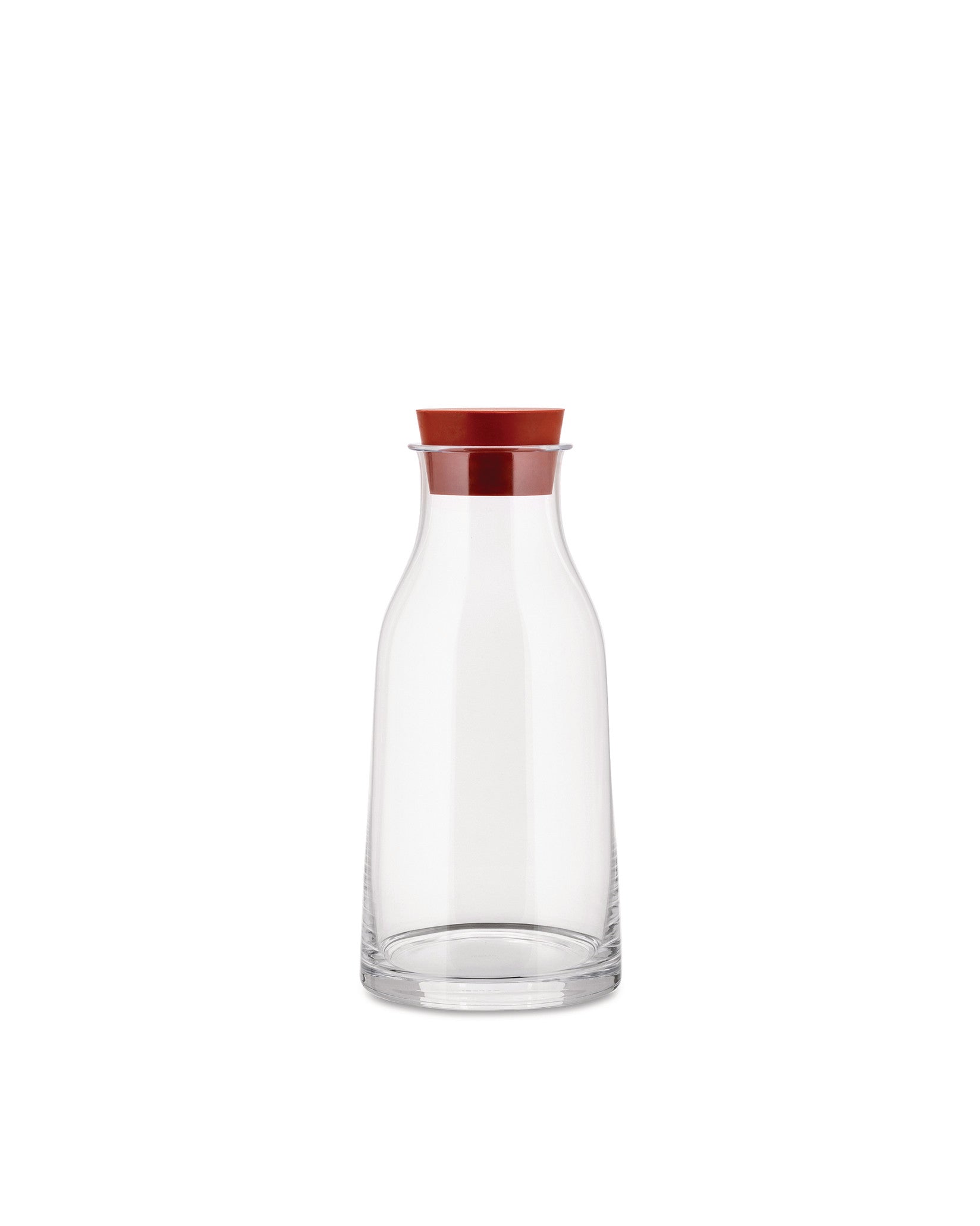 Clear glass pitcher with a reddish-brown stopper by Alessi, featuring a smooth, minimalist design.