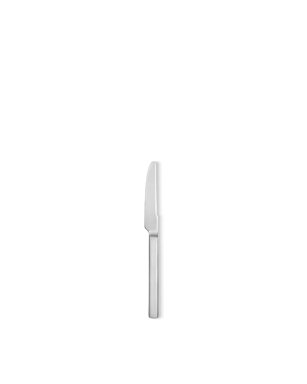 Silver serrated dinner knife by Alessi, with a sleek modern design, standing vertically on a white background.