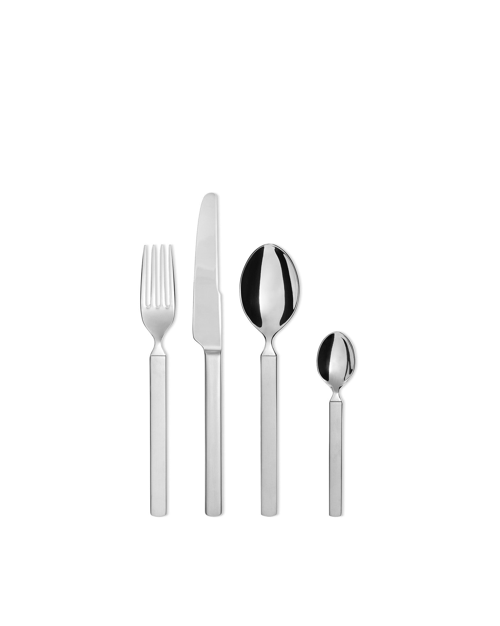 Silver four-piece cutlery set by Alessi, including a fork, knife, dinner spoon, and teaspoon with matte handles.