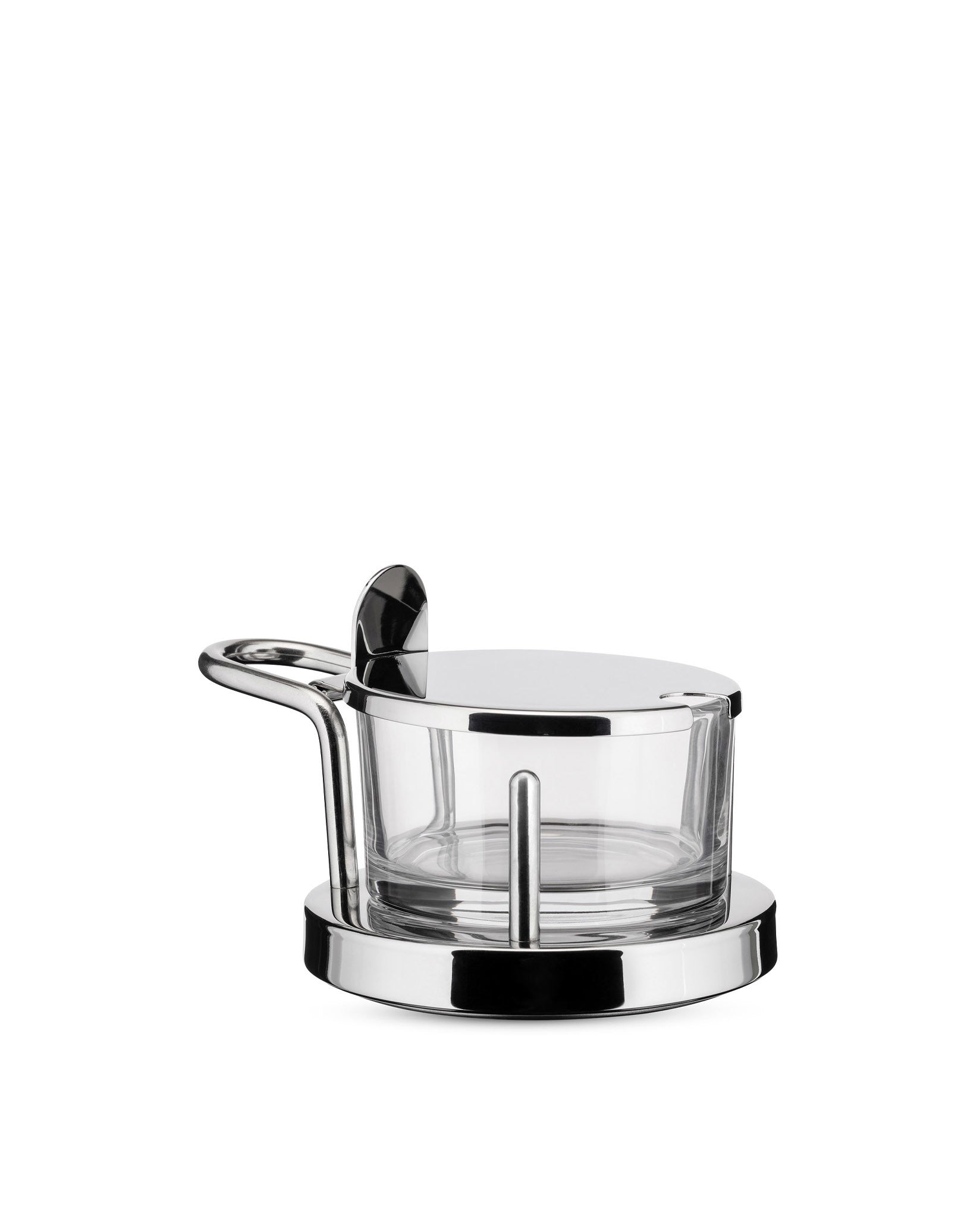 Chrome and glass cheese cellar by Alessi with a matching lid and serving spoon on a white background.