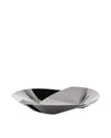 Sculptural silver-toned bowl by Alessi with a unique faceted design reflecting light and shadow.
