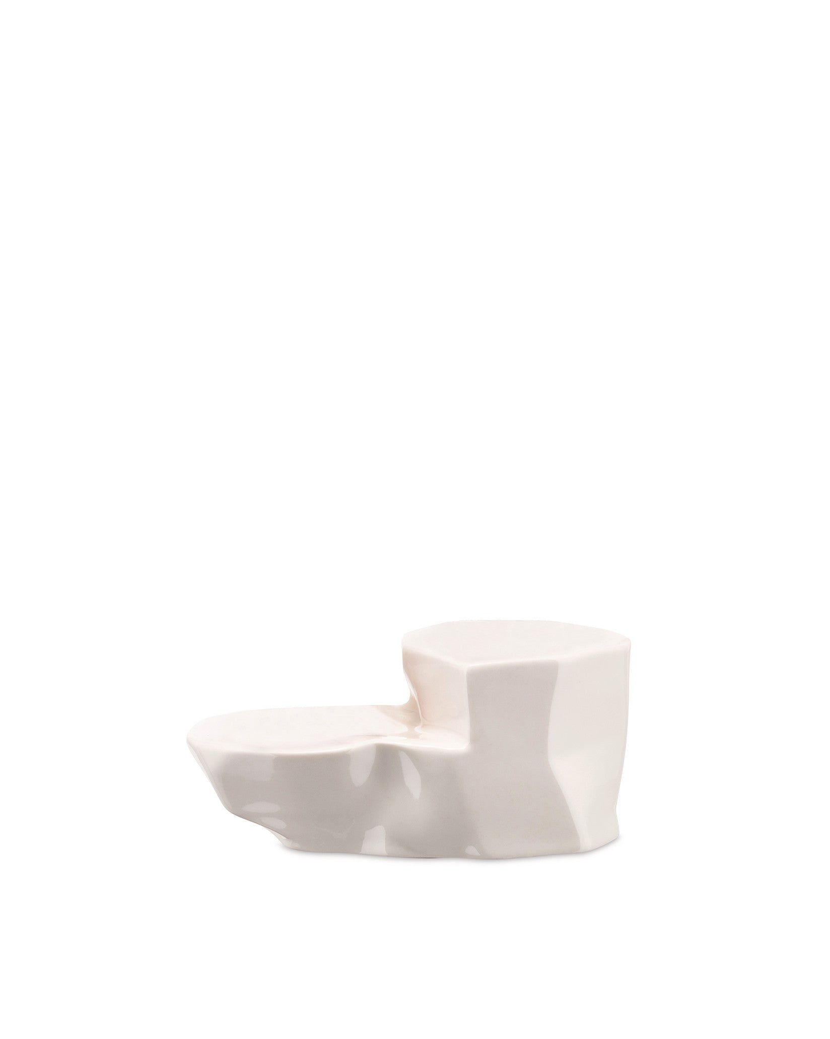 Creamy white tiered serving dish by Alessi, featuring an irregular, rock-inspired design and a smooth, glossy surface.