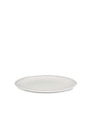 White round plate by Alessi, shown from a slight angle.