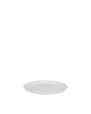 White round plate by Alessi, presented from a low angle.
